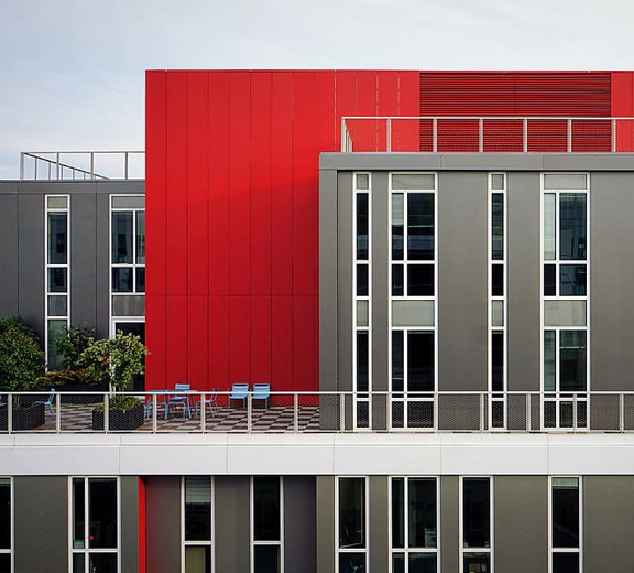 Modern commercial building with red, white and grey color scheme 