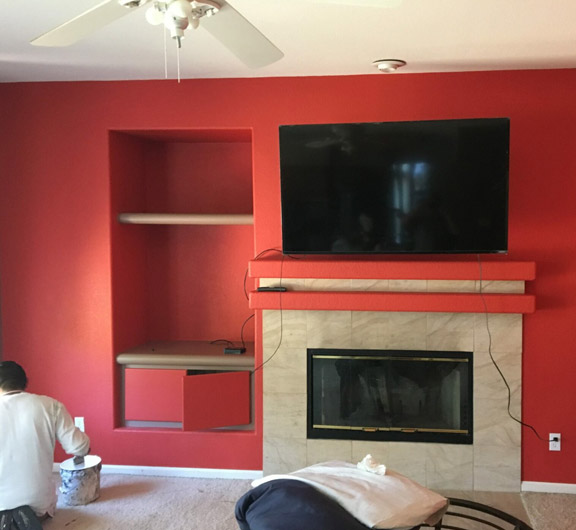 Interior home painting around a fireplace
